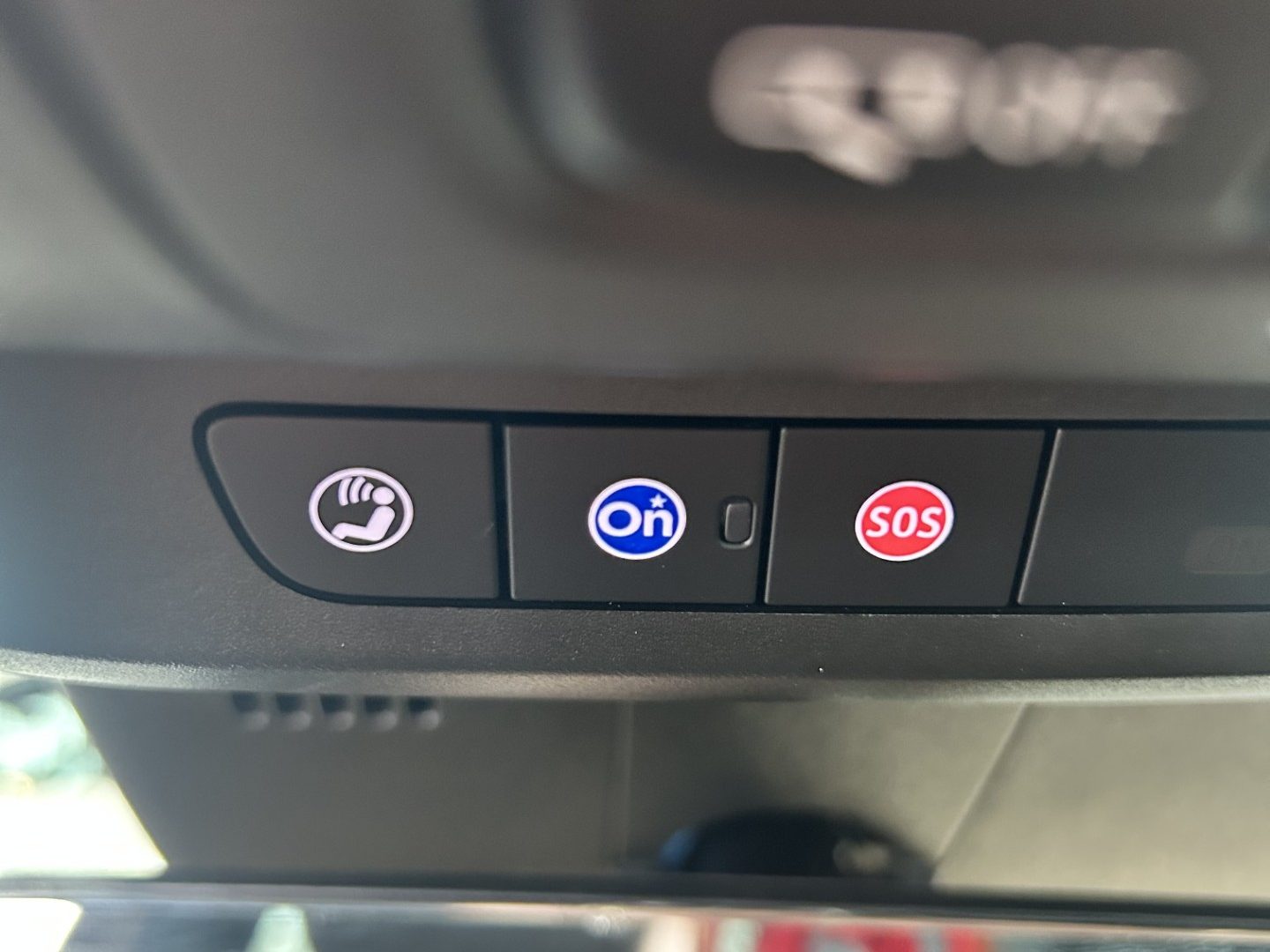 The blue OnStar button in a new Cadillac