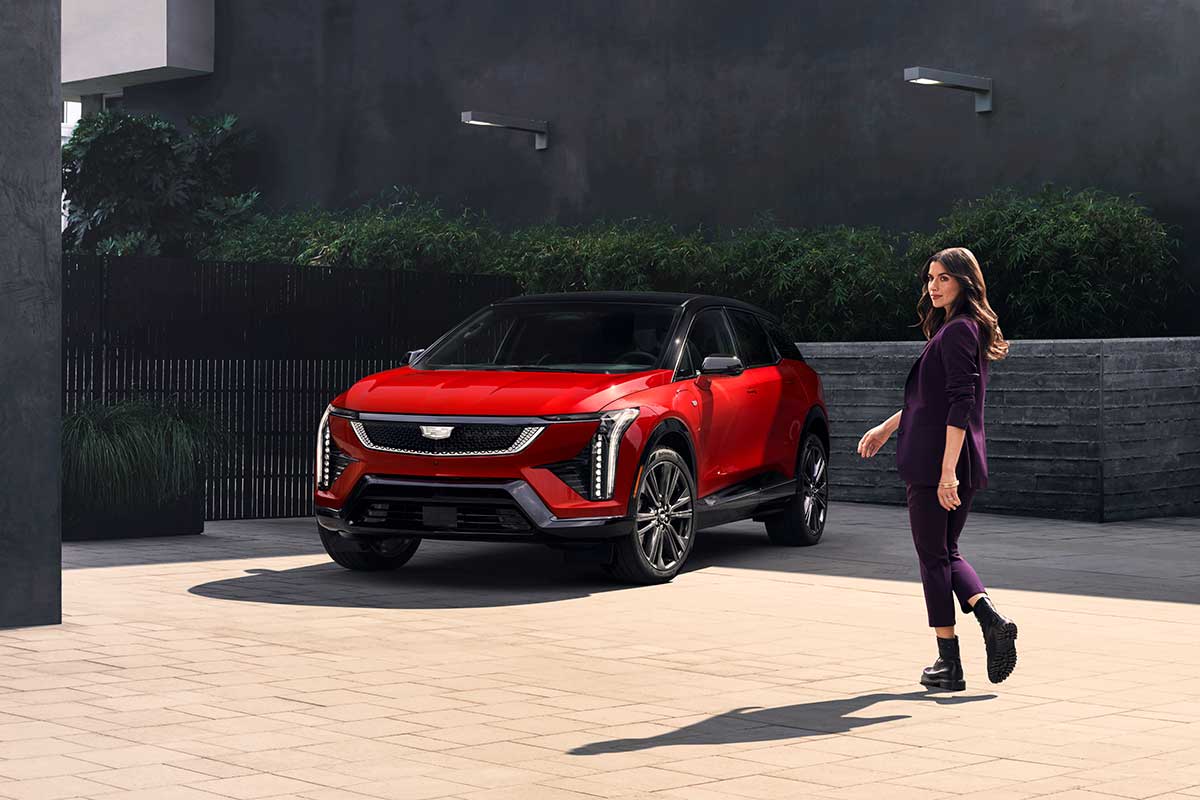 Red Cadillac Optiq compact electric SUV in a front three-quarter view